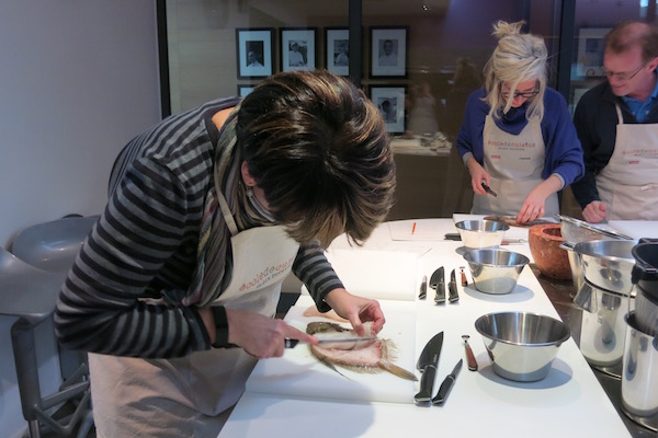 Filleting fish at Alain Ducasse Cooking School in Paris.